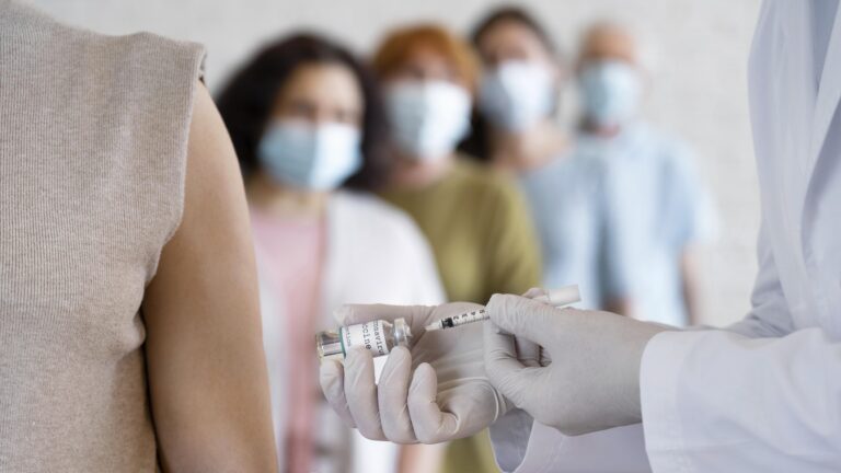 woman-getting-vaccine-shot-by-doctor